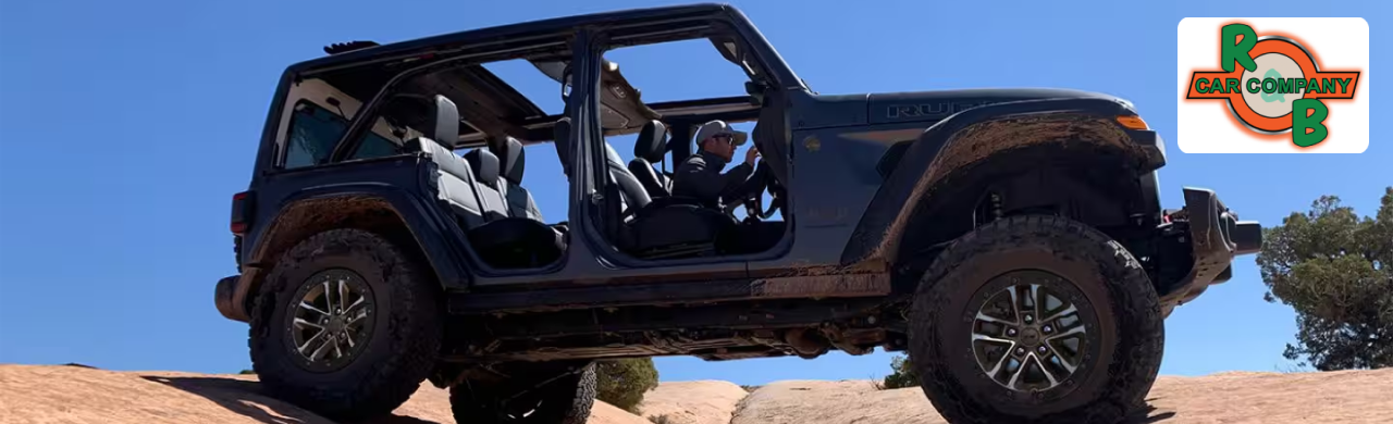 A photo of a black Jeep Wrangler with the doors on a rocky hill.